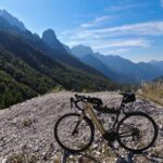 a bicycle is parked on a rocky hill
