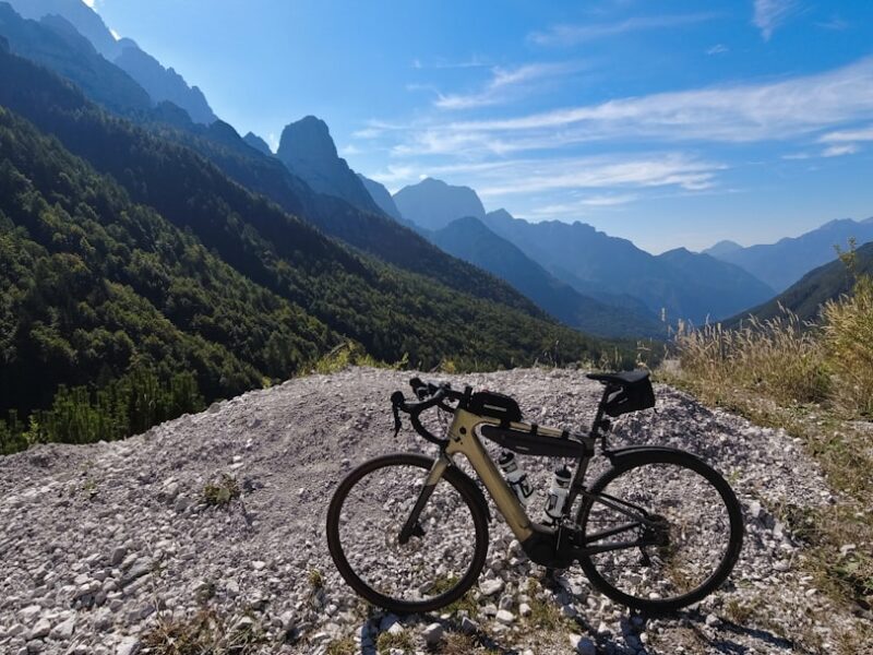 a bicycle is parked on a rocky hill