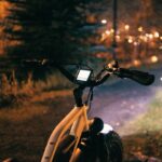 a bicycle parked on the side of a road at night