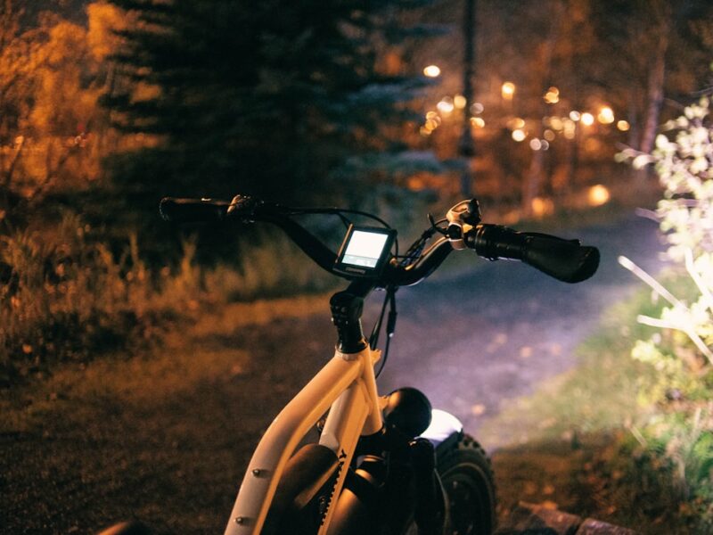 a bicycle parked on the side of a road at night