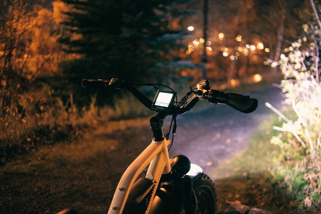 a bicycle parked on the side of a road at night