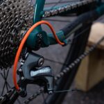 black bicycle wheel with green handle