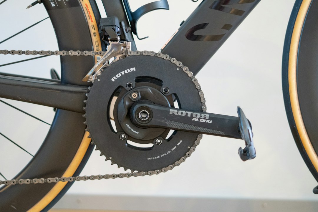 Modern bicycle's black rotor chainring and crankset with chain
